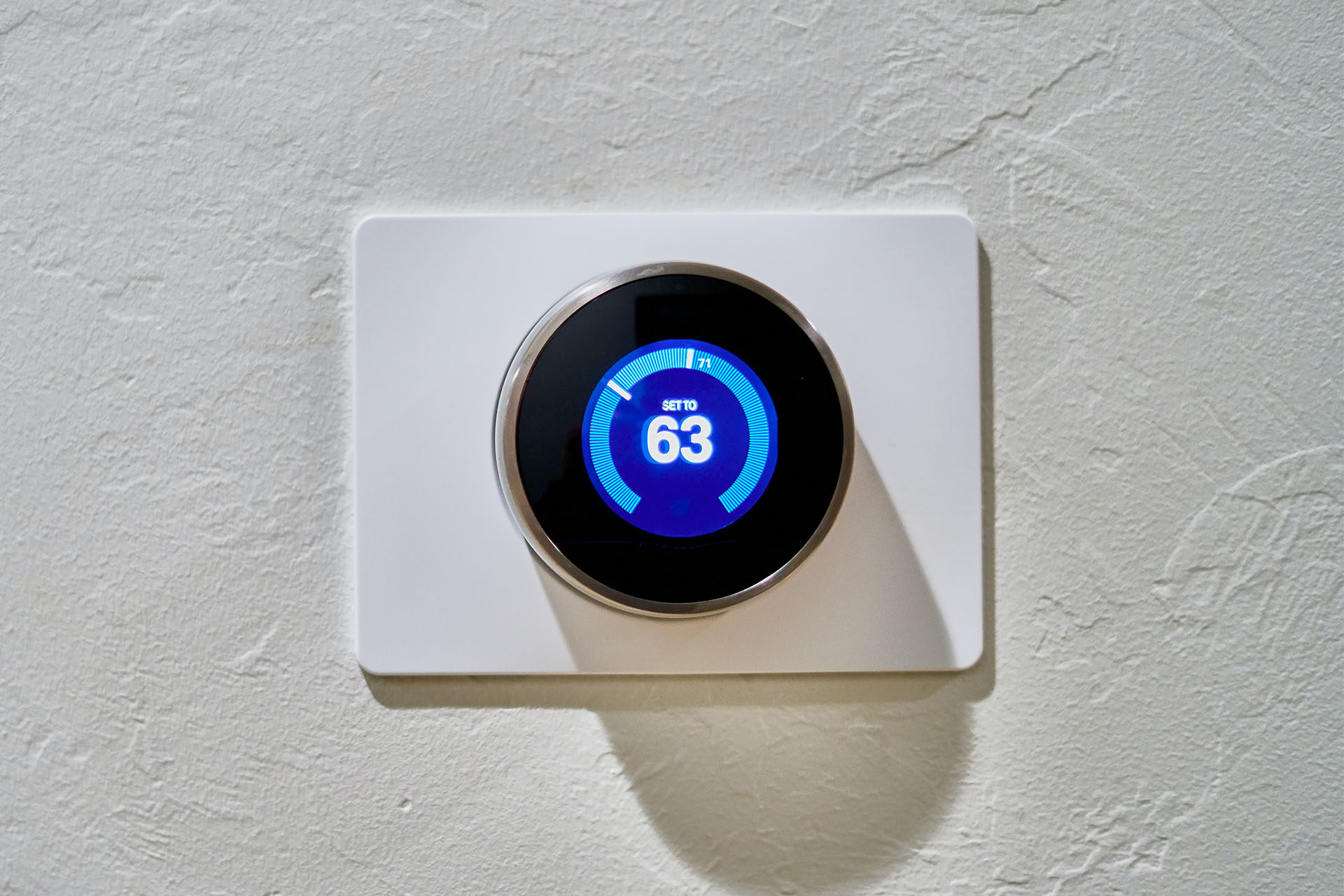 A smart thermostat mounted on a wall