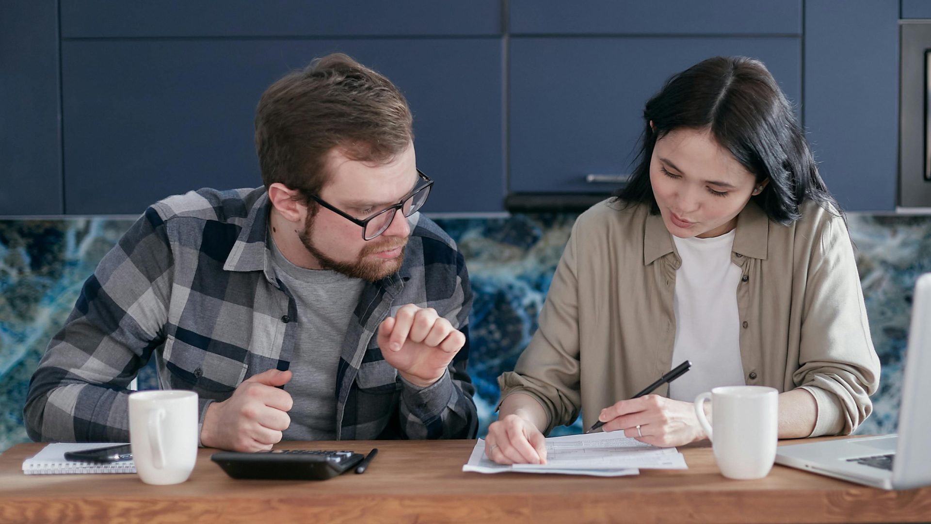 couple at a desk looking at papers