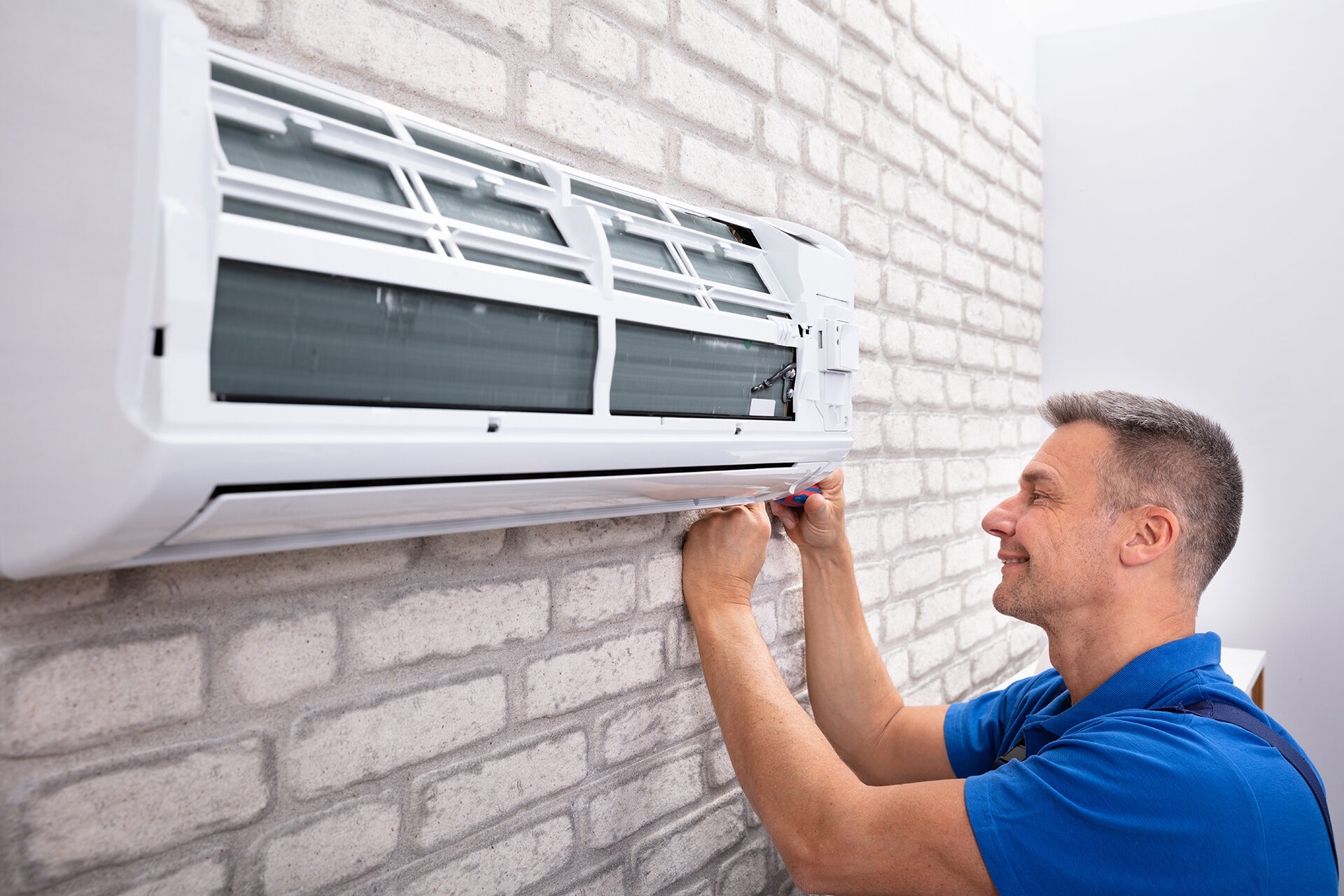 man fixing an air conditioner