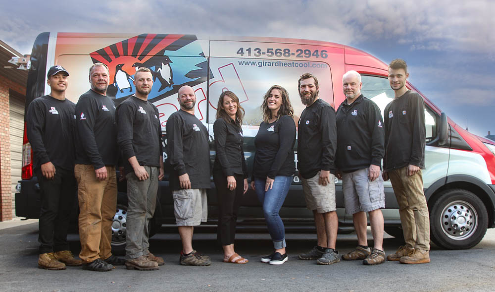 The Girard Heating and Air Conditioning team standing in front of a company van